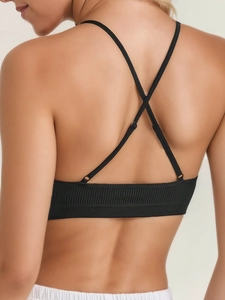 Detailed back view of a ribbed crop top featuring adjustable thin criss-cross straps