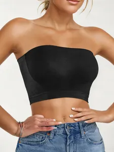 Detail shot of a black seamless strapless tube top on a model with blue jeans