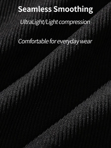 Detail of black seamless ribbed compression fabric showing smoothing texture and V-neck line