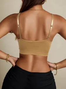 Close-up of golden brown seamless sports bra with adjustable thin straps and ribbed hem