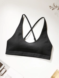 Close-up of black ribbed seamless camisole with adjustable cross back thin straps