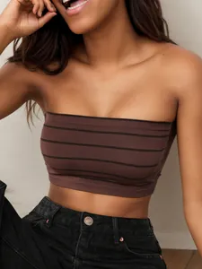 Detail of high-elasticity ribbed fabric on seamless strapless brown striped tube top