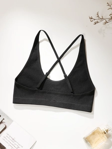 Detailed close-up of black ribbed sports bra with cross-back straps and adjustable buckles