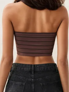 Back view of brown striped strapless bandeau bra paired with high-waisted black jeans
