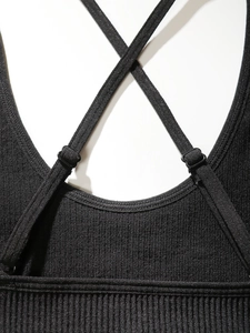 Detail of ribbed black cross back sports bra with adjustable shoulder straps and buckles