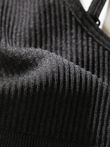 Close-up of premium black ribbed knit fabric with high elasticity and fine shimmer detail