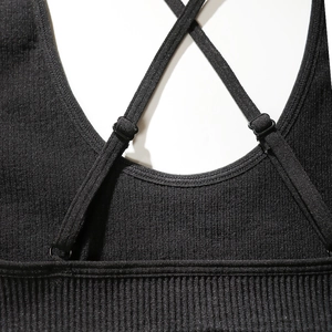 Black ribbed knit sports bra with adjustable cross back straps on white background