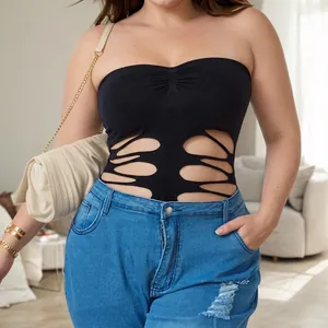 Sexy black hollowed-out tube top and ripped jeans outfit set for women in a stylish home setting