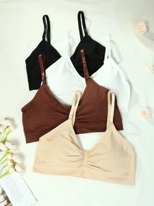 Flat lay of seamless plus size yoga bras in black, white, brown and beige colors