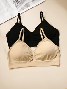 Flat lay of seamless wire-free sports bras in black and beige with thin straps