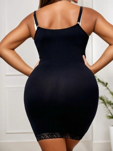 Detail shot of the back design on the black slimming bodycon dress with floral lace hem
