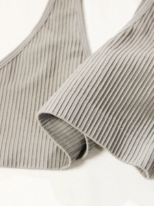 Close-up of grey ribbed knit fabric showing seamless texture and vertical stripe detail