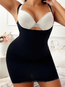 Detail view of black slimming bodysuit dress featuring delicate lace trim at the bottom hem