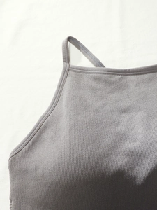 Gros plan sur le soutien-gorge de sport en tricot gris avec coutures et détails licou