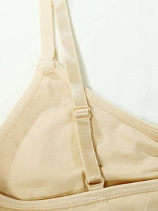 Detailed macro view of seamless nude yoga bra with adjustable elastic shoulder straps