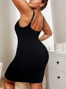 Detail of adjustable straps and low back design on a seamless black bodycon mini dress