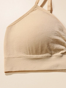 Close-up of seamless beige bralette showing soft knitted texture and stitching detail