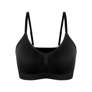 Detail of black seamless sports bra featuring adjustable thin straps and ruched center