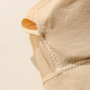 Close-up of seamless beige padded bralette showing reinforced stitching and pad slot