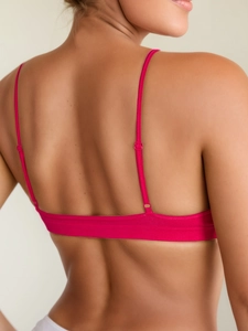 Detail of rose pink seamless yoga bra featuring thin adjustable back straps and high-stretch fabric