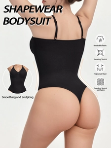 Detail of seamless black shapewear bodysuit showing thin straps and smoothing back design
