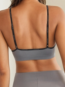 Detailed back view of a grey triangle bra with LEISURE lettered elastic straps