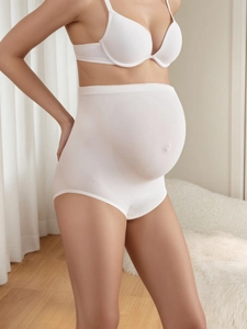 Close-up of white high-waist seamless maternity support briefs made of stretchy fabric