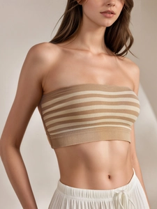 Close-up of seamless strapless bra featuring elastic ribbed edges and earth tone stripes