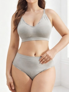 Close-up of light gray seamless sports bra and panties with LEISURE lettered straps