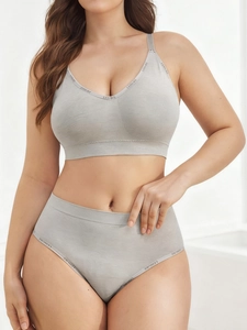 Detail of grey seamless sports bra set with LEISURE lettered elastic bands