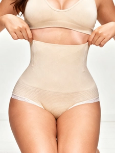Detailed view of high-waisted shaping underwear with steel bones and white lace trim
