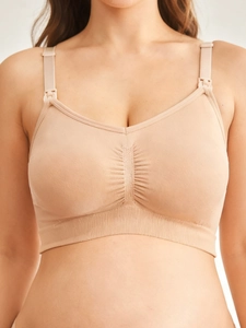 Close-up of seamless beige nursing bra with breathable fabric and front-clip nursing design