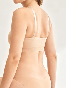 Rear view of seamless nude nursing bra and matching briefs with wide ribbed band support