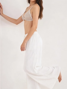 Detailed side view of white drawstring wide-leg pants and striped triangle bikini top