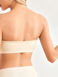 Close-up of seamless nursing bandeau bra with ribbed hem and lace trim panty in cream color