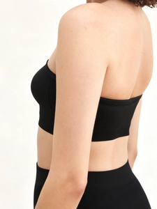 Detail view of the seamless black strapless nursing bra with high-elastic support fabric