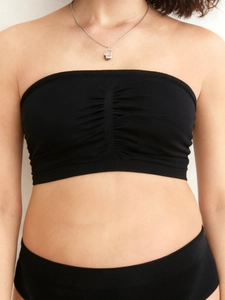 Detail of black strapless nursing bra with gathered chest design and ribbed hem
