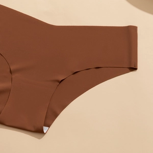 Detail of seamless laser-cut edges on brown high-stretch moisture-wicking yoga underwear