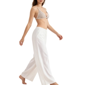 Striped halter triangle bralette paired with breathable white wide-leg linen trousers