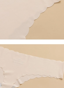 Detail showing the seamless scalloped edges and ribbed texture of nude ice silk panties
