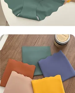 Detail of laser-cut wavy edges on seamless ice silk panties in various solid colors