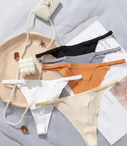 Flat lay of seamless thongs in multiple colors with thin straps on elegant background