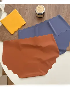 Flat lay of seamless ice silk panties in yellow, blue, and brown with scalloped edges