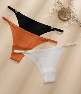 Detail of seamless thong with thin straps and golden interlaced rings decor
