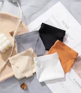 Flat lay of seamless ice silk underwear set in five colors with elegant lifestyle props