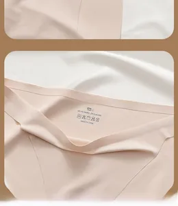 Close-up of seamless beige thong detail showing size L and 90% polyamide material composition
