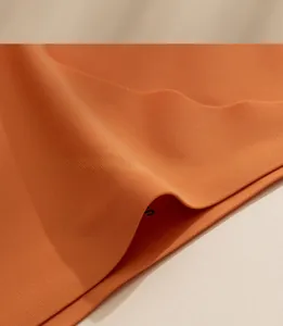 Detailed macro view of the orange seamless ice silk fabric with smooth laser-cut edges
