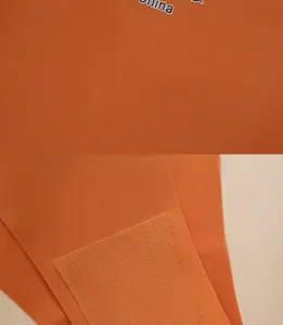 Detail of orange ice silk underwear showing double-layer cotton crotch and seamless stitching