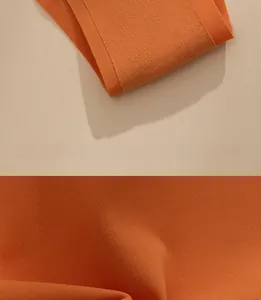 Close-up of orange seamless ice silk fabric texture with fine edge stitching and elastic knit