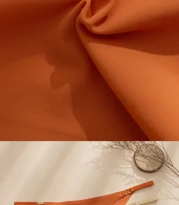 Detail of orange ice silk fabric and gold ring decorative hardware on luxury thong
